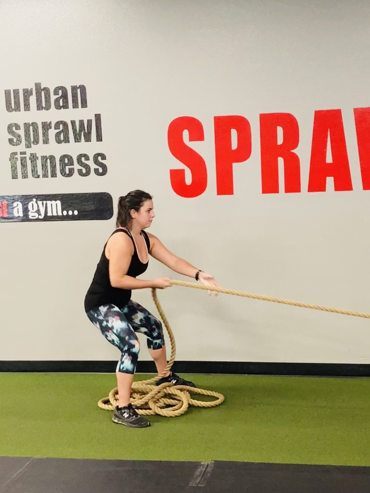 Me Working out at the gym by pulling a rope attached to a sled